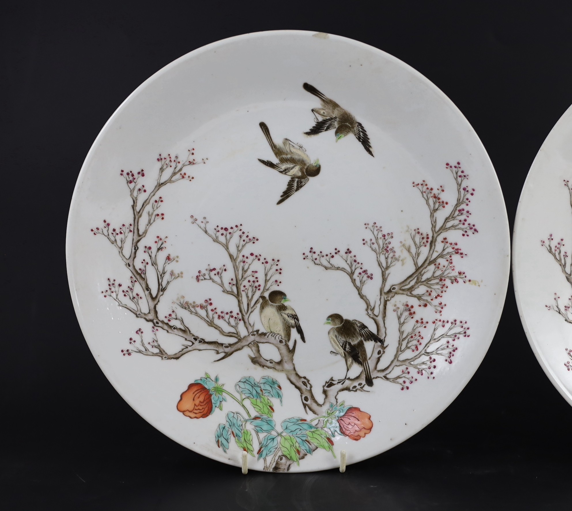 A pair of Chinese enamelled porcelain 'blackbird' dishes, Qianlong seal marks but 19th century, 27cm diameter, minor damage